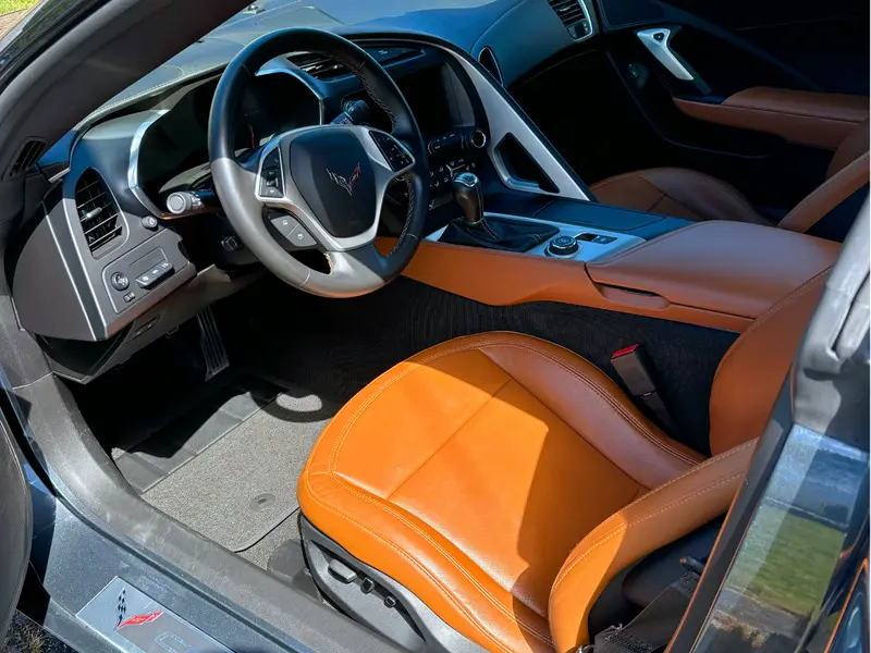 Meticulously detailed Corvette interior showing deeply cleaned leather, spotless console and restored trim